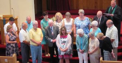 Members of the congregation standing in the sanctuary during Sunday worship