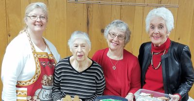 Members of the Christian Women's Fellowship with baked goods at a church event